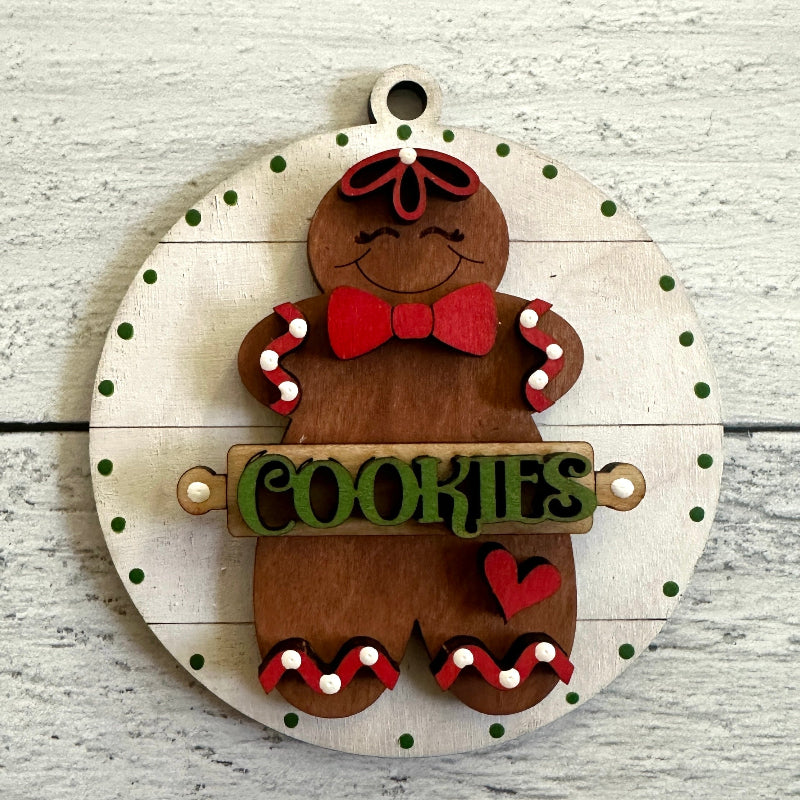 Wooden gingerbread man decoration with 'COOKIES' sign on a light wooden background